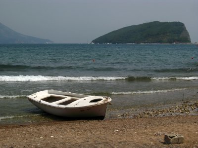 Old boat on the beach with St. Nikola beyond