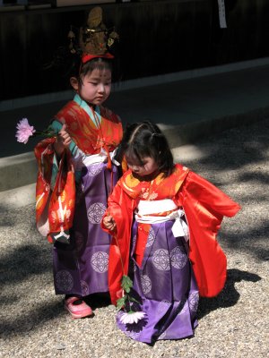 Young sisters clutching flowers