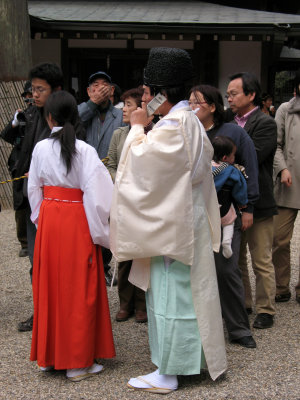 Shrine priest on his cell phone