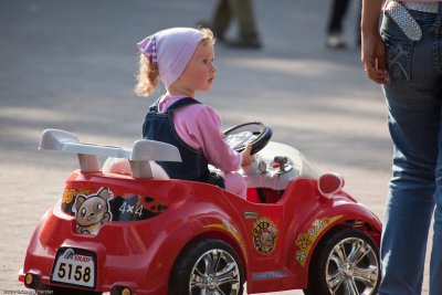 child driving in front of opera