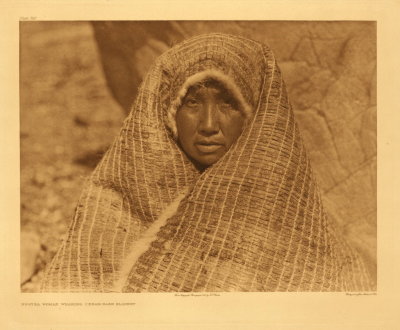 Nootka woman wearing cedar-bark blanket