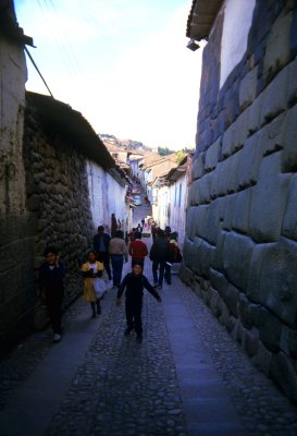 A narrow street in Cuzco . On both sides original Inca architecture.