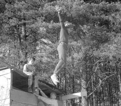 Jeff jumping off the old fort, Timmy seated, Doug climbing up.