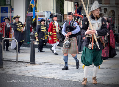 The Colchester Watch Stands Guard, As a Piper leads the procession 