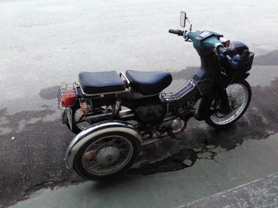 Honda Cub with two rear wheels for disabled people.