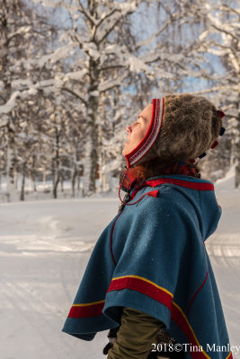 Anna, a Sami woman, enjoying a brief moment of winter sunshine.