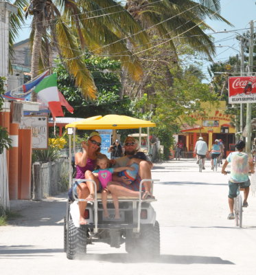 The motorized golf cart was a primary mode of transportation on the caye (pronounced 'key').
The little girl seems to be making sure Dad doesn't let her little sibling slip away.