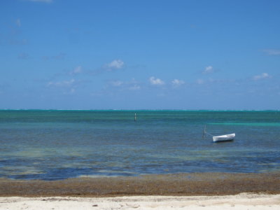 A moored boat drifting in the breeze offshore at Caye Caulker, Belize