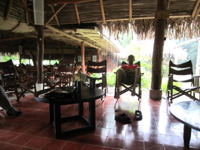 Kannan relaxes in a rocker on the covered porch.