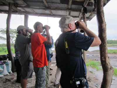 Esteban, Kannan, Steve and others under a rough shed porch at the salt ponds