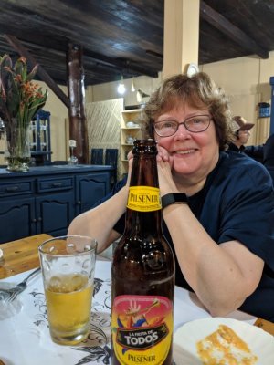 At supper, Mary enjoys a beer to celebrate a great day of birding