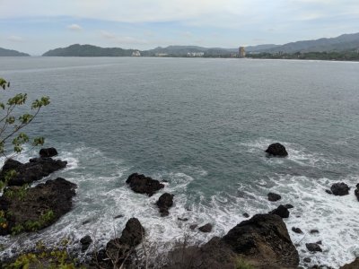 Pacific shore, looking across the bay to the town of Jaco, Costa Rica