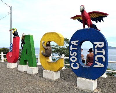 Sign for Jaco, Costa Rica, in a roadside park overlooking the bay