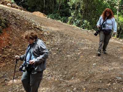 Mary and Terri step carefully down a steep curve.