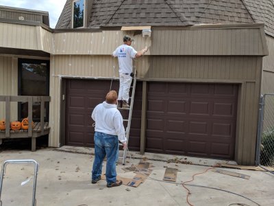 Shane and Paul painting around the light over the garage