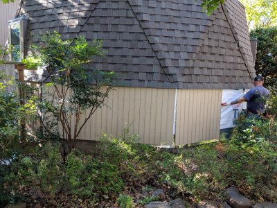 Since I had put up the fence (on the left) with screws, Jesse was able to remove three boards, so they could work more easily to put up the siding and trim.