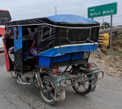 We crossed to the other side of the road and passed this three-wheeled motorcycle taxi.