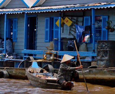 Paddling past a blue house