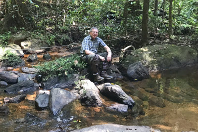 Me resting at a forest stream in Sinharaja NP