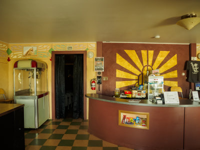 Theater interior lobby showing snack bar and popcorn machine