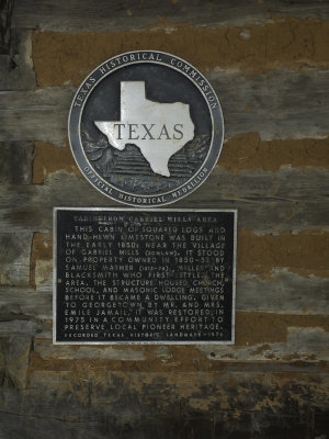 Close-up of historical plaque on cabin wall