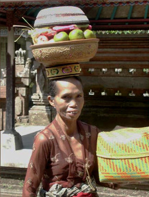 Older lady carrying temple offerings, Mengening