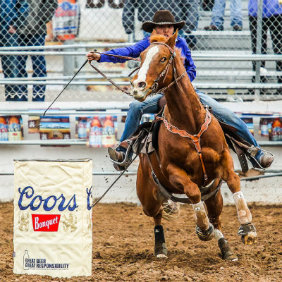 Barrel Racing competitor sprints away from the first barrel