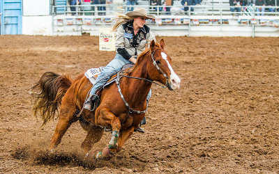 Barrel Racer Betsy Nunn prepares to maneuver around the second barrel 