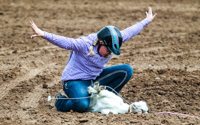 Competitor in the Goat Tie-Down Roping finishes her task