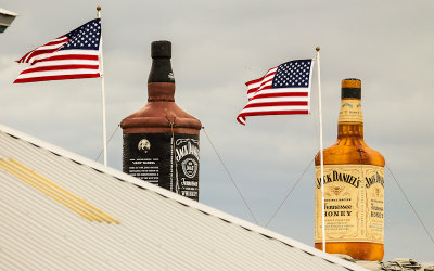 Flags and blow up Jack Daniels bottles at the Tucson Rodeo