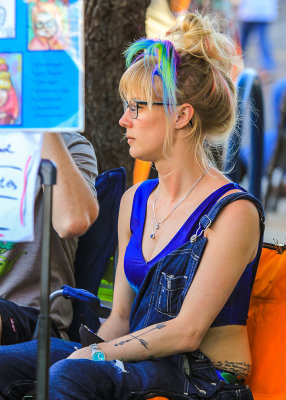Woman having her portrait done at the 4th Avenue Street Fair