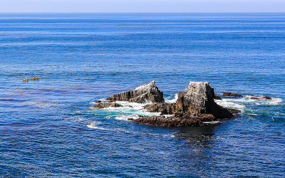 Kayakers and rock outcropping in the Pacific Ocean near Laguna Beach