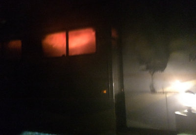 Flames rolling across the ceiling of my RV as seen through the kitchen window 