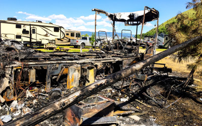 The burned out skeleton of my RV from the rear on the passenger side