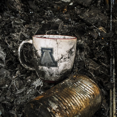 My Arizona Wildcats coffee cup in the wreckage of my burned out RV