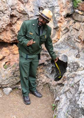 Ranger Justin shows the wind blowing into the natural entrance in Wind Cave National Park