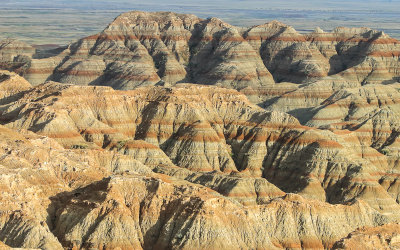 Early evening sunlight on stratified hills in Badlands National Park