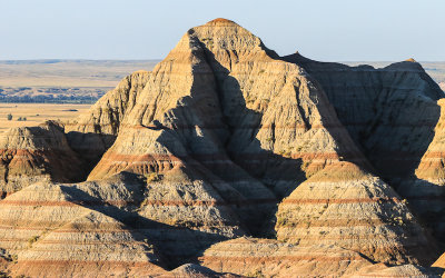 Light from the rising sun on a stratified mound in Badlands National Park