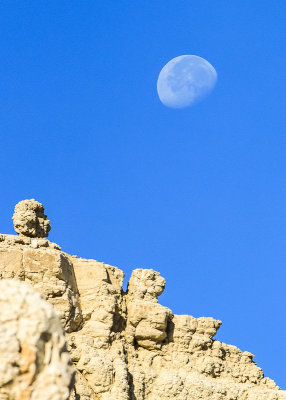 The moon appears over a peak along the Notch Trial in Badlands National Park