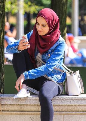 Woman checking her cell in Millennium Park in Chicago