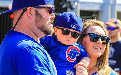 New Chicago Cubs fan for life with his parents outside of Wrigley Field