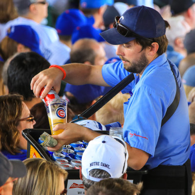 Beer vendor pours a Budweiser for a fan at Wrigley Field