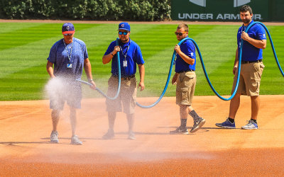 Ground crew waters down the infield at Wrigley Field