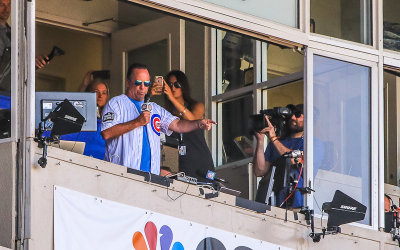 Notre Dame Basketball Coach Mike Brey sings during the seventh inning stretch at Wrigley Field
