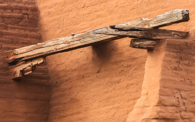 Exposed wooden beams on the side of the church in Pecos National Historical Park