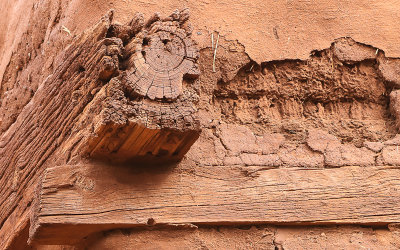 Cross beams and weathered adobe in the church in Pecos National Historical Park