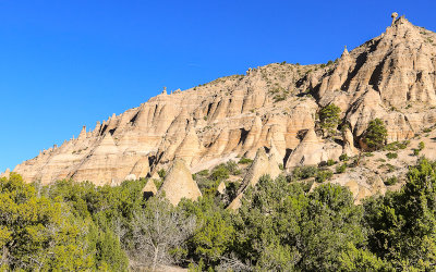 Tent rock formations tower above the valley in Kasha-Katuwe Tent Rocks National Monument