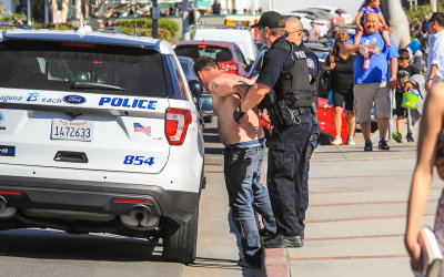 Laguna Beach Police arresting an unruly citizen in the park along the beach