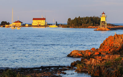 US Coast Guard building and lighthouse at sunset in Grand Marais Bay Minnesota