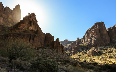 The sun glows behind a Superstition Mountain peak along the Siphon Draw Trail in Tonto National Forest